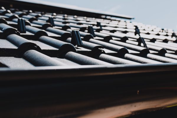 Close-up of snow guards securing metal roof tiles, ensuring safety and preventing snow slides on a residential building
